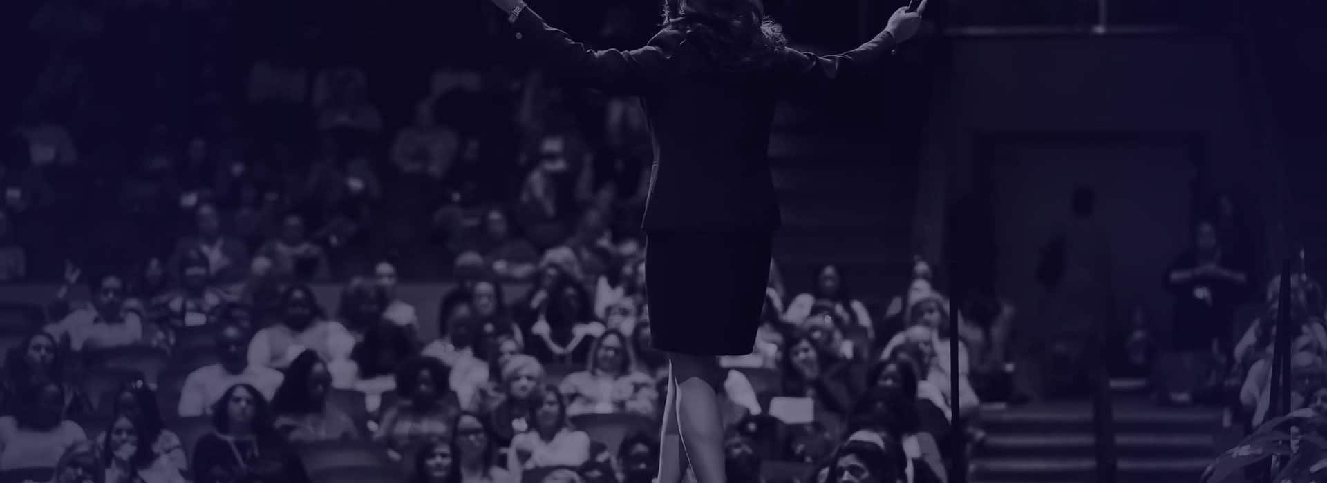 Joyce Marter speaking at a stage addressing a crowd
